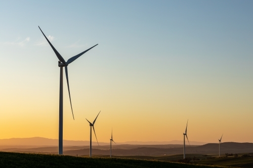 wind turbines silhouetted against late afternoon sky - Australian Stock Image