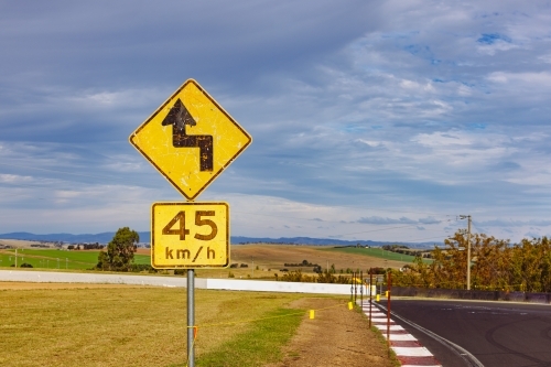 Winding road warning sign on the Mount Panorama racing circuit public road - Australian Stock Image