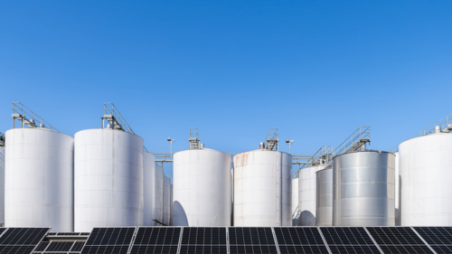 Wine processing plant with large fermenting and storage tanks and installed solar panels - Australian Stock Image