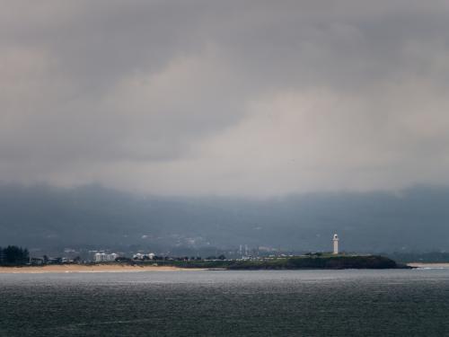 Wollongong lighthouse in a pool of light on an very overcast day - Australian Stock Image