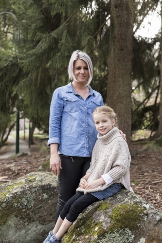 Woman and girl outdoors smiling for the camera - Australian Stock Image