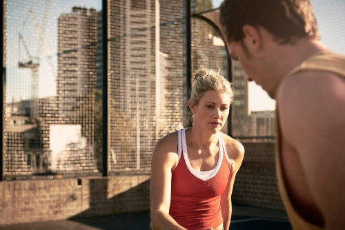 Woman and man playing one on one basketball - Australian Stock Image