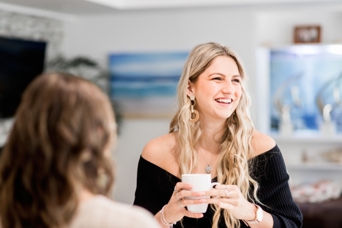 woman drinking tea, in the kitchen  - Australian Stock Image