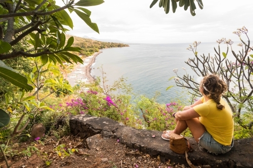 Woman looking at view from the top of a volcano - Australian Stock Image