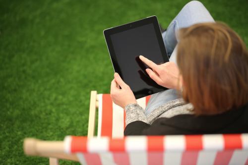 Woman on holidays using iPad - Australian Stock Image