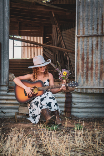 Woman playing guitar - Australian Stock Image