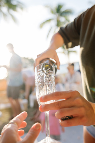 Woman pouring some champagne into a flute glass. - Australian Stock Image