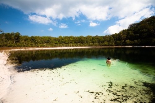 Woman swimming in a secluded lake on Fraser Island