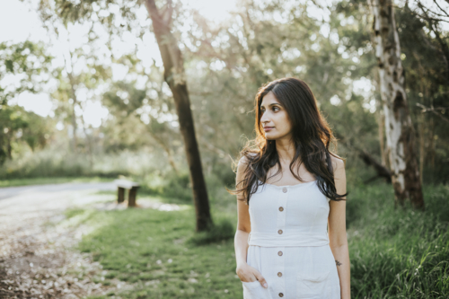 Woman walking at sunset - Australian Stock Image