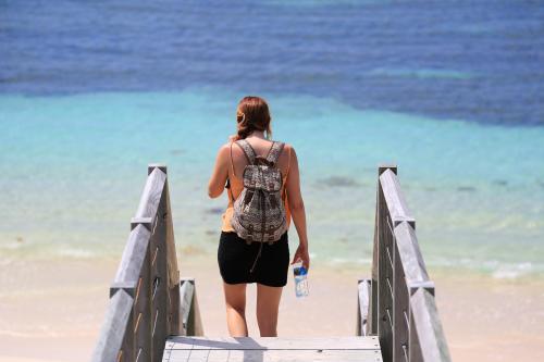 Woman walking down to beach - Australian Stock Image