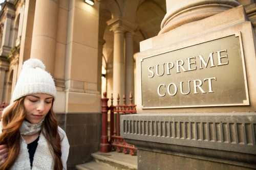 Woman walking Past Supreme Court Melbourne - Australian Stock Image