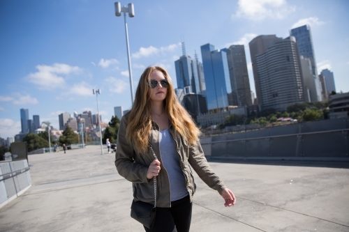Woman walking to the MCG - Australian Stock Image
