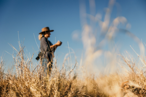 Women blurred in background flying a drone - Australian Stock Image