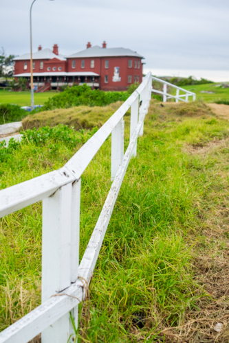 wooden fencing at La Perouse with the museum at the background - Australian Stock Image