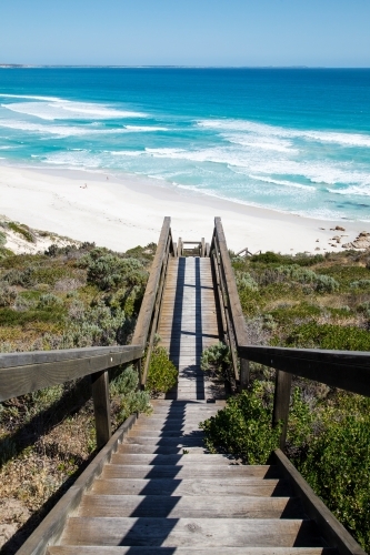 Wooden steps leading down to white sandy beach - Australian Stock Image