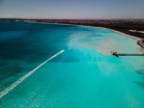 Aerial view of clear aqua ocean and shoreline with industrial wharf at Woodman Point, WA - Australian Stock Image