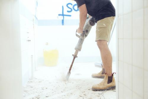 Workman jackhammering on construction site - Australian Stock Image