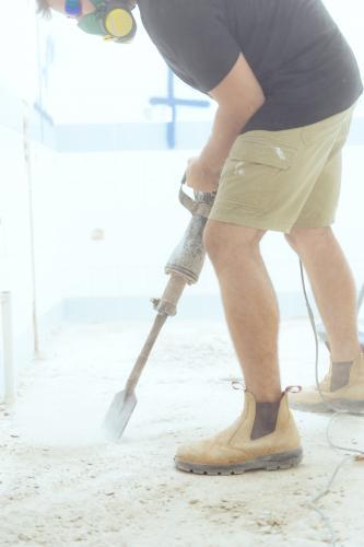 Workman jackhammering on construction site - Australian Stock Image