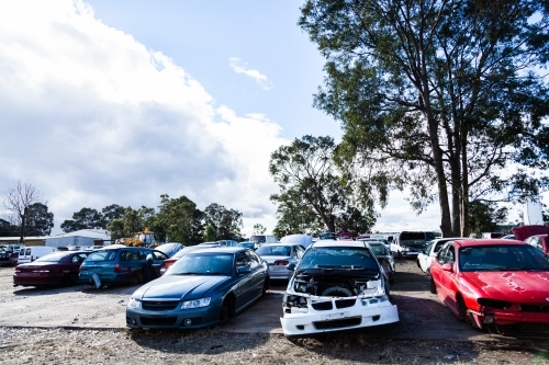 Wrecked and smashed cars parked in car wreckers junkyard - Australian Stock Image