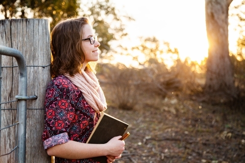 Writer with pen and journal finding inspiration in country - Australian Stock Image