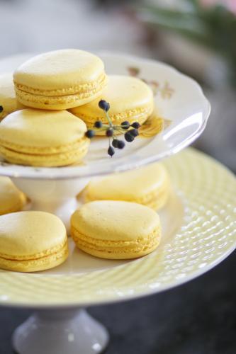 Yellow macarons on cake stand