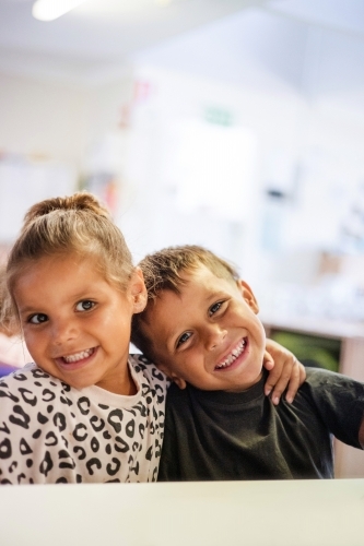 Young Aboriginal girl and boy together at preschool - Australian Stock Image