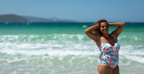 young aboriginal woman in swimsuit on the beach - Australian Stock Image