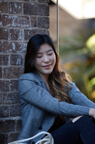 Young Asian woman enjoying time outdoors at enclave - Australian Stock Image