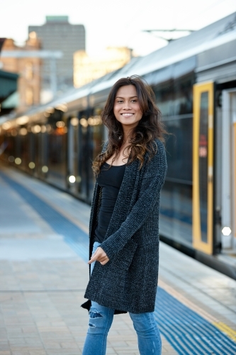 Young Asian woman waiting at train station - Australian Stock Image