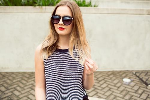 Young blonde woman posing wearing sunglasses - Australian Stock Image