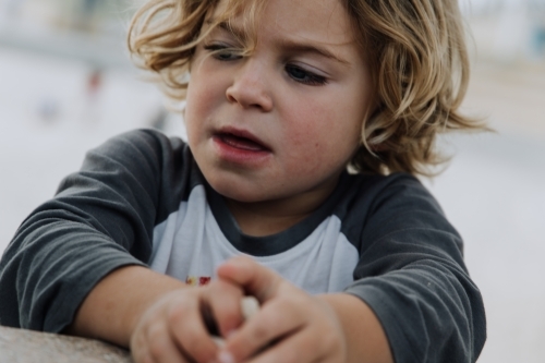 Young boy leaning on wall - Australian Stock Image
