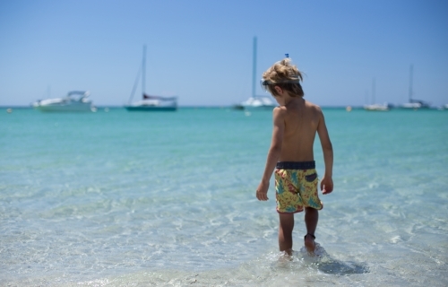 Young boy playing at beach - Australian Stock Image