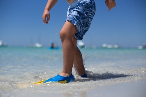 Young boy playing at beach - Australian Stock Image