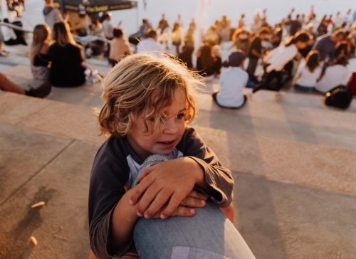 Young boy playing on mums leg - Australian Stock Image