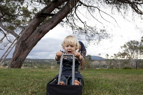 Young boy role playing outside - Australian Stock Image