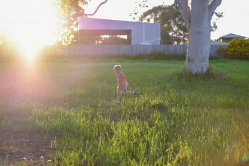 Young boy running in field - Australian Stock Image