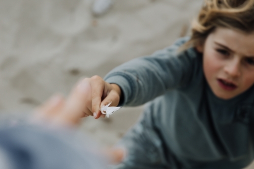 Young boy with feather - Australian Stock Image