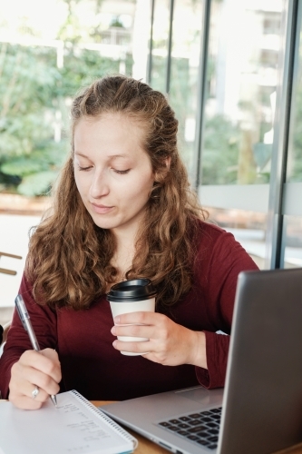 Young business woman having casual meeting at coffee shop - Australian Stock Image