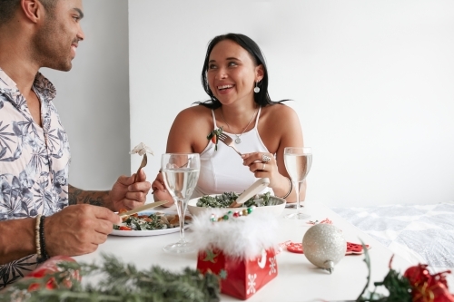 Young couple celebrating Xmas lunch together - Australian Stock Image