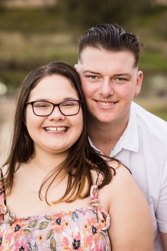 Young couple close up standing with faces together happy smiling - Australian Stock Image