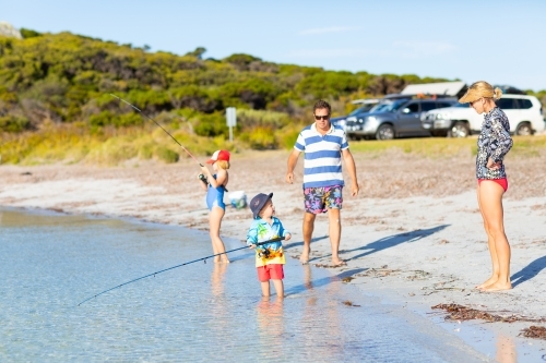 young family fishing on beach holiday - Australian Stock Image