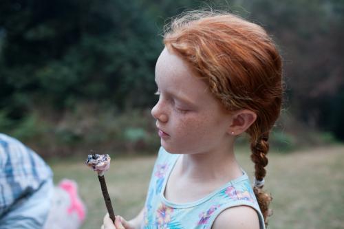 Young girl eating a toasted marshmallow