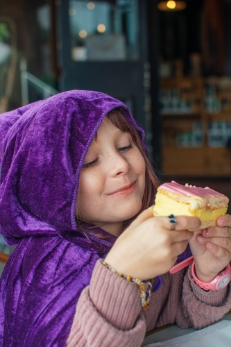 Young girl eating vanilla slice