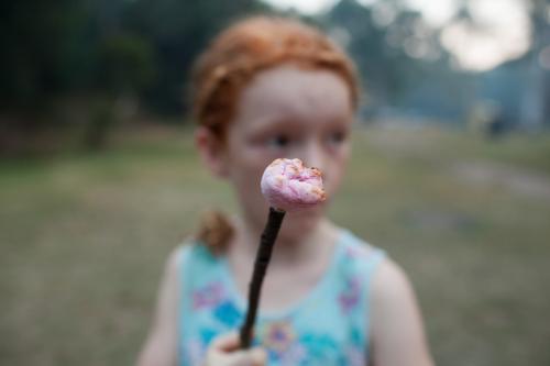 Young girl holding a toasted marshmallow