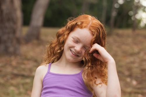 Young girl laughing in an open field