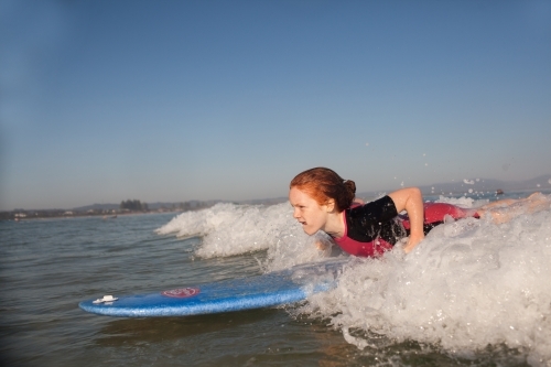 Young girl learning to surf - Australian Stock Image