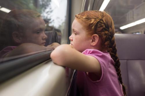 Young girl looking out the window of a train - Australian Stock Image