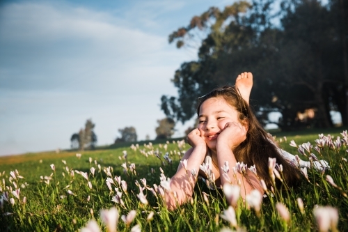 Young girl lying in field of flowers