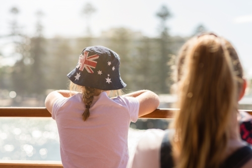 young girl on ferry to Manly, wearing an Aussie flag sun hat