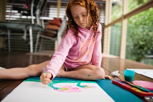 Young girl painting a picture - Australian Stock Image